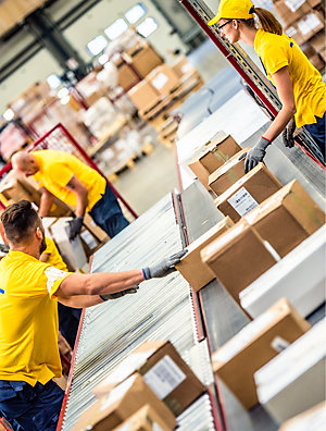 Postal workers sorting packages.