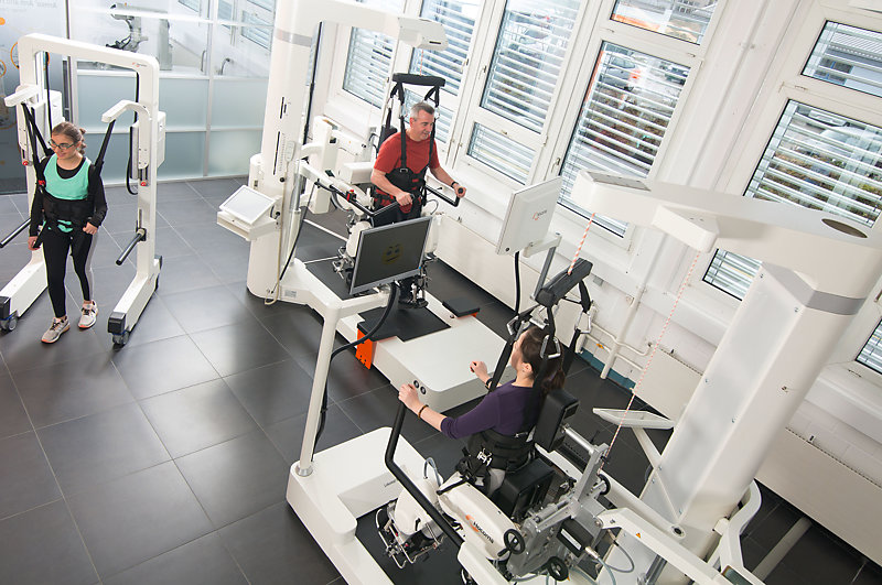 A group of people exercising on mobile robots 